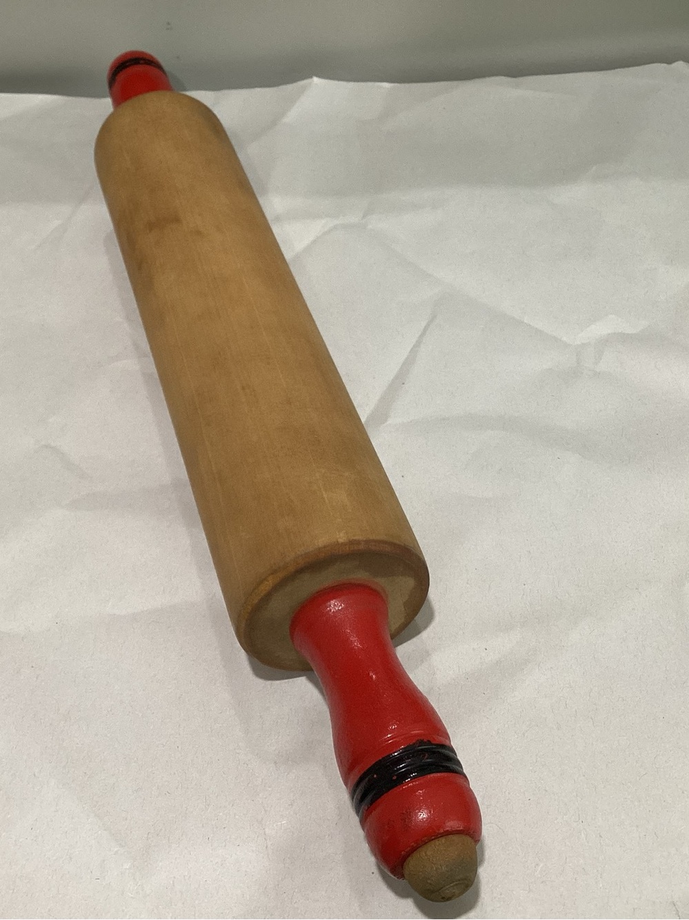 Vtg. Rolling pin with red wooden handles and black trim.